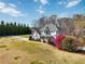 Beautiful home featuring lush landscaping, a barn, and a serene, expansive front yard at 1130 Martins Chapel Rd, Lawrenceville, GA 30045