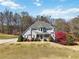Charming two-story home with manicured lawn, colorful trees, and inviting front porch at 1130 Martins Chapel Rd, Lawrenceville, GA 30045