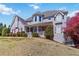 Inviting two-story house featuring charming front porch and manicured lawn on a sunny day at 1130 Martins Chapel Rd, Lawrenceville, GA 30045