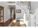 Elegant foyer featuring staircase, hardwood floors, area rug, and bench seating at 1130 Martins Chapel Rd, Lawrenceville, GA 30045