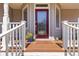 Close-up of front porch with decorative door, railings, mat, and greenery detail at 1130 Martins Chapel Rd, Lawrenceville, GA 30045