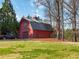 Exterior view of two-story garage featuring covered parking and additional storage or workspace at 1130 Martins Chapel Rd, Lawrenceville, GA 30045