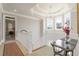 Upstairs hallway with tray ceiling, chandelier, marble table, and large windows at 1130 Martins Chapel Rd, Lawrenceville, GA 30045