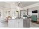 Kitchen island with sink and dishwasher overlooks a breakfast nook and living room with fireplace at 1130 Martins Chapel Rd, Lawrenceville, GA 30045