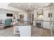 Open-concept kitchen featuring stainless steel appliances, center island, and tile flooring flowing into the living room at 1130 Martins Chapel Rd, Lawrenceville, GA 30045