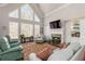 Bright living room with vaulted ceilings, fireplace, built-ins, and large windows at 1130 Martins Chapel Rd, Lawrenceville, GA 30045