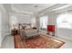 Spacious main bedroom with tray ceiling, carpet, windows, and decorative accent wall at 1130 Martins Chapel Rd, Lawrenceville, GA 30045