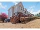 Home exterior with a large deck, multilevel stairs, and beautiful backyard at 1130 Martins Chapel Rd, Lawrenceville, GA 30045