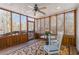 Relaxing screened porch with wood paneled walls, ceiling fan, and view of the backyard at 1130 Martins Chapel Rd, Lawrenceville, GA 30045