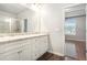 Bright bathroom featuring dual sink vanity with granite countertop and a separate shower room at 1640 Andalusian Way, Conyers, GA 30012