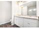 Bathroom with double sink vanity, granite countertop, and large mirror at 1640 Andalusian Way, Conyers, GA 30012