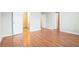 Bright bedroom featuring hardwood floors and views to the ensuite bathroom and closets at 1640 Andalusian Way, Conyers, GA 30012