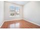 Bedroom featuring hardwood floors, large window, and neutral paint color at 1640 Andalusian Way, Conyers, GA 30012