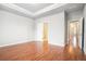 Spacious bedroom features tray ceiling, hardwood floors, and ensuite bathroom at 1640 Andalusian Way, Conyers, GA 30012