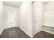 Entryway featuring luxury vinyl plank flooring, convenient coat rack and bench, and access to the backyard at 1640 Andalusian Way, Conyers, GA 30012