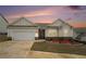 Charming single-story home featuring a two-car garage, landscaped yard, and stone accents at 1640 Andalusian Way, Conyers, GA 30012