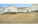 View of the back exterior showing neutral siding and a patch of dead grass at 1640 Andalusian Way, Conyers, GA 30012