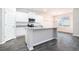 Bright kitchen features white cabinets, stainless steel appliances, granite countertops, and a kitchen island at 1640 Andalusian Way, Conyers, GA 30012