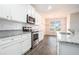Modern kitchen with white cabinetry, stainless steel appliances, and granite countertops at 1640 Andalusian Way, Conyers, GA 30012