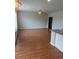 Open-concept living room featuring hardwood flooring, a ceiling fan, and abundant natural light at 1640 Andalusian Way, Conyers, GA 30012