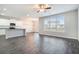 Open-concept living room and kitchen area with hardwood floors, ceiling fan, and natural light at 1640 Andalusian Way, Conyers, GA 30012