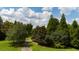 Aerial view of lush, wooded property with verdant trees and a winding driveway under a cloudy sky at 2100 West Wesley Rd, Atlanta, GA 30327