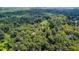 A beautiful aerial view features a lush green canopy with a home nestled in the trees at 2100 West Wesley Rd, Atlanta, GA 30327
