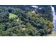 Aerial view featuring a winding river and a home surrounded by a lush green landscape of trees at 2100 West Wesley Rd, Atlanta, GA 30327