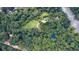 Overhead view of dense tree coverage along the riverbanks with houses barely visible underneath at 2100 West Wesley Rd, Atlanta, GA 30327