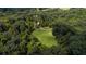 Overhead shot of wooded estate featuring a pond, sweeping lawn, and winding driveway leading to the home at 2100 West Wesley Rd, Atlanta, GA 30327