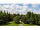 Aerial view of lush, wooded property with verdant trees and a winding driveway under a cloudy sky at 2100 West Wesley Rd, Atlanta, GA 30327