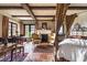 Stylish bedroom with wooden beams, a cozy fireplace, and French doors at 2100 West Wesley Rd, Atlanta, GA 30327