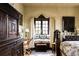 Bright bedroom with a window seat, ornate furnishings, and elegant decor at 2100 West Wesley Rd, Atlanta, GA 30327