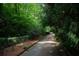 A long, tree-lined driveway provides privacy to the home at 2100 West Wesley Rd, Atlanta, GA 30327