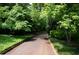 A long, tree-lined driveway leads to a secluded home at 2100 West Wesley Rd, Atlanta, GA 30327