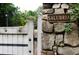 Close-up of a Salubria entrance sign in a stone wall by a white wooden gate at 2100 West Wesley Rd, Atlanta, GA 30327