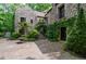 Stone home featuring a courtyard with manicured greenery, a stone staircase, and architectural details at 2100 West Wesley Rd, Atlanta, GA 30327