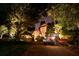 Beautiful stone home at night, featuring a vintage car parked in the driveway and illuminated landscaping at 2100 West Wesley Rd, Atlanta, GA 30327