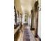 Elegant hallway with arched doorways, decorative rug, and vintage decor showcases classic style at 2100 West Wesley Rd, Atlanta, GA 30327