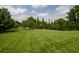 Spacious, manicured lawn with mature trees on a sunny day at 2100 West Wesley Rd, Atlanta, GA 30327