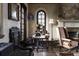Charming living room featuring vintage decor, including a phonograph, fireplace, and unique furniture at 2100 West Wesley Rd, Atlanta, GA 30327