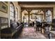 Comfortable living room with wooden beams, large arched windows, and vintage decor at 2100 West Wesley Rd, Atlanta, GA 30327