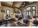 Inviting living room with a stone fireplace, decorative mural, and ample natural light at 2100 West Wesley Rd, Atlanta, GA 30327