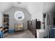 Cozy attic space with a round window, storage, and wood-look flooring, perfect for organization and style at 3174 Country Club Nw Ct, Kennesaw, GA 30144