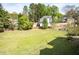 Expansive backyard featuring lush lawn and mature trees, creating a serene outdoor space at 3174 Country Club Nw Ct, Kennesaw, GA 30144