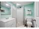 Bathroom with a modern shower stall, sink, and toilet, all in a fresh, clean design at 3174 Country Club Nw Ct, Kennesaw, GA 30144