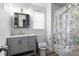 Charming bathroom with a gray vanity, floral shower curtain, and natural light at 3174 Country Club Nw Ct, Kennesaw, GA 30144