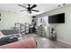Comfortable bedroom with a ceiling fan, large window, and modern décor at 3174 Country Club Nw Ct, Kennesaw, GA 30144