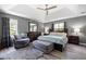 Spacious bedroom with a tray ceiling, ceiling fan, stylish furniture, and natural light at 3174 Country Club Nw Ct, Kennesaw, GA 30144