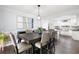 Elegant dining room with modern lighting, a large table, and open access to the kitchen at 3174 Country Club Nw Ct, Kennesaw, GA 30144